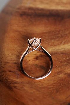 a diamond ring sitting on top of a wooden table