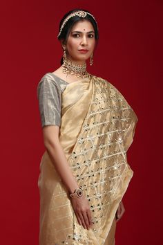 Golden saree highlighted with geometric mirror motif embroidery. Comes with blouse.
Component: 2
Embroidered
Sleeve Length: Short Sleeves
Fabric: Tissue
Color: Gold
 - Aza Fashions Festive Gold Pre-draped Saree With Mirror Work, Elegant Festive Kundan Blouse Piece, Festive Elegant Kundan Blouse Piece, Festive Blouse With Dupatta In Chinon, Eid Tissue Silk Traditional Wear With Mirror Work, Eid Traditional Tissue Silk Wear With Mirror Work, Eid Traditional Wear With Mirror Work In Tissue Silk, Transitional Gold Traditional Wear With Mirror Work, Gold Blouse Piece With Mirror Work For Eid