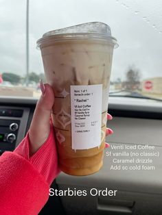 a woman holding up a cup of coffee in her hand with information about the drink