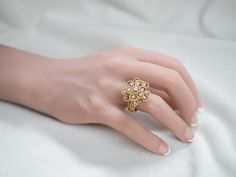 Absolutely stunning! This vintage, Mid-Century cocktail ring features a gleaming array of diamonds orbiting around an open work twisting gold center. This is a wonderful combination of sexy and yet sophisticated, easy to transfer from office to evening. Perfectly proportioned and very well balanced, this vintage cluster ring is a bold, but comfortable piece!Metal: 18K Yellow GoldGem: 18 Diamonds totaling 1.08 Carats, SI1 in Clarity, G in ColorGem Measurements: 3.5 mm, RoundRing Size: 9.25Marks: “18K HB” Stamped on the inside band Elegant Evening Rings With Center Stone, Elegant Cluster Ring With Rose Cut Diamonds, Elegant Evening Diamond Ring With Center Stone, Elegant Open Diamond Ring For Party, Elegant Party Rings With Rose Cut Diamonds, Elegant Yellow Gold Diamond Ring For Party, Elegant Rose Cut Diamond Rings For Parties, Elegant Wedding Bypass Ring With Diamond Accents, Gold Rings With Single Cut Diamonds For Evening