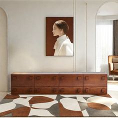 a living room with a large rug and painting on the wall