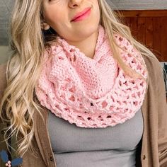 a woman wearing a pink crocheted scarf