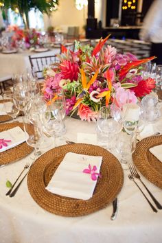 a table set with place settings and flowers