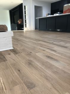 an empty living room with wood floors and white brick boxes on the floor in front of it