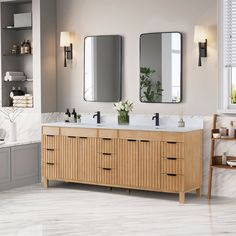 a bathroom with two sinks and mirrors on the wall