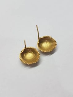 "Handmade, seashell summer earrings. These gold stud earrings were created by casting real seashells, collected on the beach and casting them in 14k gold plated brass. The shell earrings are nature inspired and are really beautiful to wear every day for an elegant and fun look. Dimensions: The seashells are 1x1 cm (0.4x0.4\") The earrings are available both in 14 karat plating and sterling silver. They are also available as drop earrings - see last 2 photo or follow the link below: https://www.e Bridal Earrings Studs, Vintage Stud Earrings, Earrings Beach, Earrings Nature, Dainty Band, Seashell Earrings, Beach Earrings, Gold Bridal Earrings, Nature Earrings