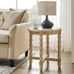 a living room scene with focus on the end table and lamp in the foreground