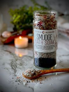 Our Smudge Bath Soak is a great way to cleanse and clear your aura. This soak includes palo santo, roses and hyssop botanicals. We blend the botanicals with black salt, Himalayan salt and epsom salt. The essential oils used are rose, frankincense, clove, holy basil & palo santo. 8 oz. | Packaged in an 8 ounce capacity reusable glass jar. INGREDIENTS | black salt, epsom salt, himalayan salt, rose petals, hyssop, white sage, palo santo, essential oils of: clove, rose, palo santo, holy basil and fr Bath Salts Packaging Ideas, Botanical Business, Bath Salts Diy, Bath Recipes, Black Salt, Herbal Bath, Herbal Magic, Holy Basil, Homemade Bath Products