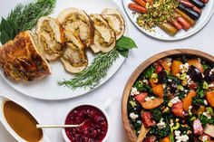 three plates of food on a table with bread, cranberry sauce and carrots