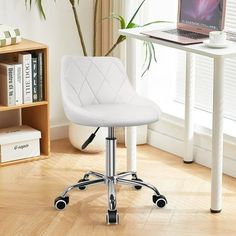 a white office chair sitting in front of a laptop computer