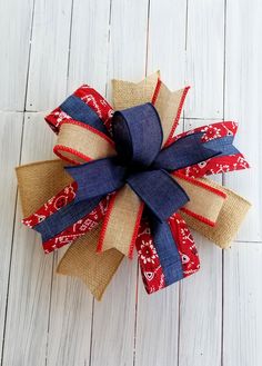 a red, white and blue bow sitting on top of a wooden floor