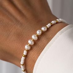 Discover timeless elegance with our Freshwater Pearl Bracelet. Featuring white beads and gold accents, this handcrafted bracelet is a perfect gift or versatile accessory for any occasion. - Wear daily to elevate your casual or office attire. - Perfect accessory for formal occasions like weddings or parties. - Gift for birthdays, anniversaries, or special celebrations. - Elegant addition to any jewellery collection. - Adjustable bracelet design for a comfortable, secure fit. - Comes beautifully p Meaningful Christmas Gifts, Gold Beaded Bracelet, Elegant Jewellery, Bracelet Elegant, Jewellery For Women, Handcrafted Bracelets, Freshwater Pearl Bracelet, Simple Bracelets, Bracelet Design