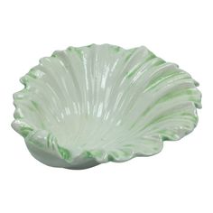 a green and white bowl sitting on top of a table