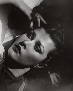 a black and white photo of a woman laying down