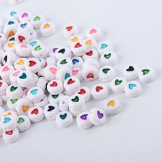 small white beads with multicolored hearts on them