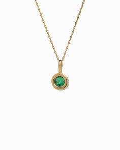 Crafted in 14K solid gold, the Princess Petroglyph Stone Pendant features a faceted green zircon stone encircled by intricate petroglyphs. Its unique design adds a touch of elegance to any outfit, and pairs wonderfully with our Princess Petroglyph Stone Studs. Metal: 14K solid gold Stone: Green zircon Dimensions: 16mm x 8mm Stone Size: 8mm Style #: GP160GZ Oval Birthstone Jewelry In Recycled Gold, Luxury Green Round Jewelry, Gold Tsavorite Emerald Necklace For May Birthstone, Gold Jewelry With Bezel Setting For May Birthstone, Yellow Gold Birthstone Necklace With Bezel Setting, Heirloom Jewelry With Bezel Setting In Recycled Gold, Classic Jewelry With Bezel Setting In Recycled Gold, Classic Jewelry In Recycled Gold With Bezel Setting, Green Round Stone Necklace For Formal Occasions