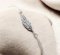 Discover the perfect blend of elegance and bohemian charm with our stunning 925 Sterling Silver Feather Bracelet. Handcrafted with love and precision, this exquisite piece is designed to be both versatile and timeless. Adorn your wrist with a delicate feather motif, meticulously crafted from premium 925 sterling silver, ensuring you shine with a touch of nature-inspired beauty. Measuring 7/8 inches in width and 3/16 inches in length, this bracelet is adjustable from 6 1/2 inches to 7 1/2 inches, making it a perfect fit for any wrist size. Crafted with the highest quality materials, this sterling silver bracelet is stamped with the coveted 925 mark, symbolizing its purity and authenticity. Whether you're dressing up for a special occasion or adding a touch of sophistication to your everyday Bohemian Sterling Silver Bracelets For Party, Bohemian Sterling Silver Bracelet For Parties, Bohemian Sterling Silver Party Bracelets, Elegant Adjustable Sterling Silver Nickel-free Bracelet, Bohemian Bracelets With Lobster Clasp For Party, Bohemian Party Bracelets With Lobster Clasp, Bohemian Sterling Silver Bracelet With Lobster Clasp, Bohemian Style Sterling Silver Bracelet As Gift, Silver Feather Bracelet