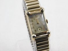 Vintage Collectible Bulova 21 Jewel Art Deco Tank Style Watch. Movement is a 7AK which dates it to 1936 and has been completely serviced, cleaned, oiled and running great. Great Style from the 1930's. Glass Crystal is, I believe the original one and although it has scratches on it, is still in nice condition. The band is a nice Spiedel band from the same era. I can change out to a leather band if you would like. Case size is 21mm x 37 mm. I believe the open holes in each corner are hearts that w Mens Gold Chain Necklace, Jewel Art, Men Jewellery, Gold Chains For Men, Small Jewelry Box, Style Watch, Jewelry Lookbook, Mens Gold, Watch Movement