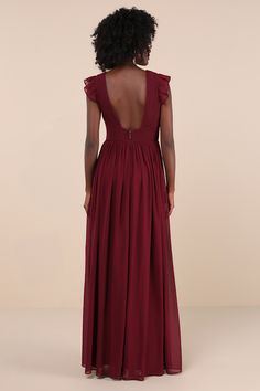 the back of a woman in a long red dress