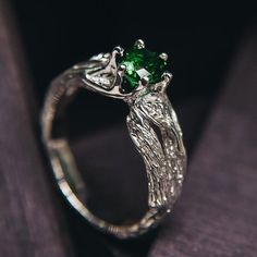 "Step into the enchanting world of autumn with this elegant silver leaf ring adorned with a shiny emerald. Ideal for nature lovers, it captures the essence of the season in a stunning piece of jewelry. This ladies' emerald green ring is a tribute to the beauty of plants and nature, making it a unique and cherished addition to your collection. DETAILS: Stone - 6mm Lab Grown Emerald Metal - recycled solid Sterling Silver Dimensions - width 6mm (0.23 in.), band width - 3mm (0.118 in.) Finish - oxidized (shiny at your request - shown in the last 3 photo) HOW TO ORDER ▪   Simply choose your ring size and a gemstone in dropdown menus. ▪   Add an engraving you'd like to have inside in the 'Personalization Box' (optionally). ▪   Feel free to contact me if you want to change anything about the ring Nature-inspired Green Emerald Ring For May Birthstone, Nature-inspired Emerald Ring For May Birthstone, Nature-inspired Ring With May Birthstone For Gift, Sterling Silver Green Promise Ring, Green Sterling Silver Promise Rings, Green Promise Rings With Nature-inspired Style, Nature-inspired Green Emerald Gemstone Ring, Nature-inspired Emerald Promise Ring, Nature-inspired Emerald Ring