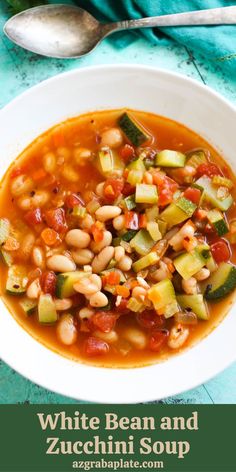 white bean and zucchini soup in a bowl with spoons on the side