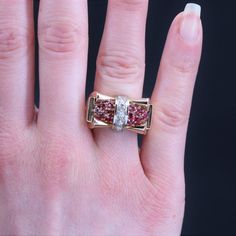 This is part of Chairish’s Fine Jewelry assortment.  Ring in 18 karat rose gold, eagle head hallmark, and platinum.  Knot ring, it is formed of a geometric tray tightened in the center by a link set with 5 brilliant- cut diamonds on platinum.  On either side, 2x6 round synthetic rubies form the decoration.  Total weight of diamonds : 0.15 carat approximately.  Height : 13,5 mm approximately, width : 2,2 cm approximately, thickness : 7 mm approximately.  Total weight of the jewel : 11,4 g approxi Geometric Tray, Vintage Cocktail Ring, Gold Eagle, Eagle Head, Knot Ring, Ruby Diamond, Gold Platinum, Brilliant Cut Diamond, Cocktail Rings