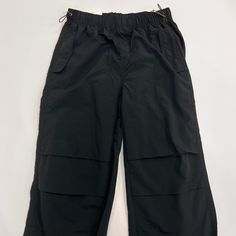 Women's Solid Nylon Parachute Pants – K MOMO Black Functional Nylon Bottoms, Functional Black Nylon Bottoms, Black Stretch Techwear Parachute Pants, Black Wide Leg Bottoms For Outdoor Activities, Black Wide-leg Bottoms For Outdoor Activities, Nylon Wide Leg Bottoms For Outdoor Activities, Black Baggy Parachute Pants For Outdoor, Baggy Black Parachute Pants For Outdoor, Black Nylon Techwear Pants