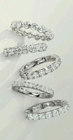 three different types of wedding rings with diamonds on them, all in white gold and silver