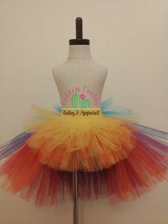 This high low tutu is next level. Over 100 yards of tulle, short in the front, long in the back with tiered layers creating a wild look. Sizing Info: 1-3T is roughly 6 inches long in the front 3-5T is roughly 8 inches long in the front Add your color choices in the notes at check out. Spring Rainbow Tutu Dress With Ruffles, Whimsical Rainbow Tulle Tutu Dress, Whimsical Multicolor Tulle Tutu Dress, Summer Tiered Tulle Tutu Dress, Playful Rainbow Tulle Tutu Dress, Fitted Multicolor Tutu Dress For Summer, Summer Tiered Tutu Dress With Tulle Skirt, Fitted Multicolor Tutu Dress With Ruffles, Whimsical Multicolor Fitted Tutu Dress