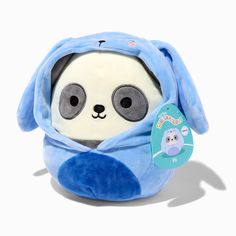 a stuffed animal with a blue scarf around it's neck and eyes, sitting on a white surface