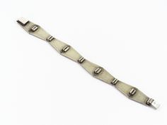 "ArtDecoGalaxy presents: an Art Deco cubistic sterling silver bracelet inlaid with ebony with a box lock, circa 1940s. Measures 20cm (7.87\") long by 2,2cm (0.87\") wide. Wear consistent with use and age, no damage or repairs, in excellent vintage condition. The shipping cost is for Standard Registered Mail. Please contact us to combine shipping or to request Express shipping. For all Countries not figured in the shipping list please contact us for a quote and shipping details. We will consider Star Art, Stone Necklace, Chain Link Bracelet, Sterling Silver Bracelets, Beautiful Necklaces, Silver Bracelet, Art Deco, Personalized Items, Chain