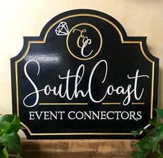 a black and gold sign that says south coast event connectors on it's side