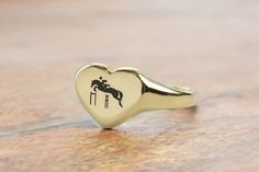 Celebrate a passion for horses with our Custom Gold Heart Shaped Signet Ring, exquisitely crafted with an equestrian design. This romantic ring is perfect for any horse enthusiast or equestrian rider who cherishes the elegance and freedom horses represent. The heart shape symbolizes love and devotion, making it an ideal gift for special occasions such as birthdays, anniversaries, or Valentine's Day. Made from high-quality gold, this personalized ring showcases your love for riding and the equest Equestrian Ring, Dna Jewelry, Romantic Rings, Equestrian Lifestyle, Fancy Gifts, Heart Shaped Rings, Personalized Rings, Unique Handmade Jewelry, Heart Of Gold