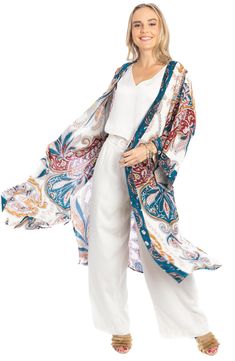 Love to layer all of your look in this bohemian-inspired duster that is covered in a bright medallion pattern. Open front Short sleeves 100% rayon Hand wash, line dry Imported Model stats: 5'10", 32" bust, 25" waist, 36" hip. Model is wearing size One Size. Bohemian Spring Outerwear With Paisley Print, Bohemian Outerwear With Paisley Print For Spring, Summer Bohemian Patterned Outerwear, Multicolor Bohemian Outerwear With Paisley Print, Bohemian Multicolor Paisley Print Outerwear, Bohemian Patterned Beach Outerwear, Blue Bohemian Rayon Kimono, Bohemian Long Printed Outerwear, Bohemian Blue Outerwear For Vacation