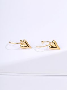 Also available in SILVER These elegant Heart Clip-On Hoop Earrings are the perfect adornment for any outfit. Crafted from gold-plated metal, the design features a heart-shaped charm that hangs delicately from a simple hoop. The clip-on closure ensures these earrings are comfortable and secure all day. MATERIALS Thick 18k gold-plated stainless steel SIZE & WEIGHT 20mm diameter hoop, 14.7mm charm drop approx. 2.5g per earring approx. No piercings required Sold as a pair Features our signature resi Elegant Double Heart Huggie Earrings With Heart Charm, Elegant Heart-shaped Single Cartilage Earring, Elegant Heart Charm Huggie Earrings For Valentine's Day, Elegant Hoop Heart Earrings For Pierced Ears, Elegant Heart Hoop Earrings, Heart-shaped Clip-on Earrings For Valentine's Day, Heart-shaped Clip-on Wedding Earrings, Elegant Clip-on Heart Earrings For Valentine's Day, Wedding Heart-shaped Clip-on Earrings