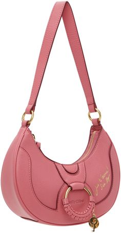 LWG-certified grained goatskin shoulder bag in pink. · Detachable shoulder strap · Logo and text embossed at face · O-ring, braided leather trim, and logo charms · Zip closure · Cotton twill lining · H6 x W9 x D2.5 Supplier color: Pushy pink Shell Bag, Fancy Bags, Pretty Bags, Chloe Bag, See By Chloe, Braided Leather, Half Moon, O Ring, Leather Trim