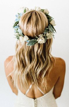 a woman with long blonde hair wearing a flower crown on her head and white dress