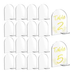 twelve clear acrylic table numbers with yellow lettering on each one and two sides