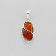 These is a beautiful Sterling Silver Pendant with Amber. The pendant is made out of solid 925 Silver and there is no nickel or other substances causing most allergies. This makes the pendant hypo allergenic. Size of the Pendant in total - with the bail 3.7 x 1.5 cm or  1.46 x 0.59 inch Please note: Our jewelry is photographed close up to show detail and may appear larger than they are. We are happy to help with any questions. We use a dime coin as size reference on one of the pictures. You will Modern Oval Amber Jewelry, Modern Amber Oval Jewelry, Sterling Silver Jewelry With Shiny Finish And Oval Shape, Oval Sterling Silver Jewelry With Shiny Finish, Oval Silver Jewelry With Shiny Finish, Nickel-free Oblong Sterling Silver Jewelry, Hypoallergenic Silver Oval Jewelry, Classic Sterling Silver Oblong Jewelry, Polished Oblong Sterling Silver Jewelry