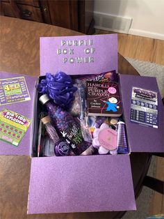 the purple box of power is sitting on top of a table with its contents in it