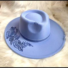 This Blue Western/ Boho Hat Features Florals On The Brim And A Feather Tucked To The Side Of The Blue Velvet Ribbon Hat Band. S/M Polyester Trendy Blue Hats For Festival, Trendy Blue Hat For Festival, Trendy Adjustable Blue Fedora, Trendy Blue Hat With Flat Brim, Casual Adjustable Blue Fedora, Casual Blue Hat Bands For Festivals, Trendy Blue Wide Brim Hat, Blue Brimmed Felt Hat For Kentucky Derby, Blue Flat Brim Felt Hat For Kentucky Derby