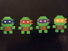 four perler beads are arranged in the shape of teenage mutants, one is wearing a tmnt mask