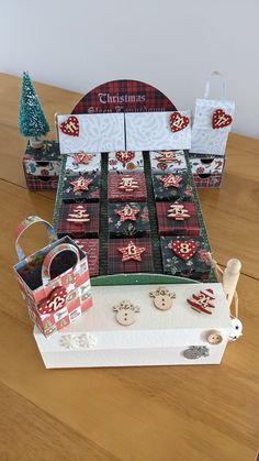 a table topped with boxes filled with christmas decorations