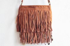 Made with combination of genuine suede leather (fringe, strap,body), faux suede (body) -Lined interior with magnetic snap and a back pocket that closes with zipper -Adjustable, leather shoulder strap - can be worn across the body or on the shoulder -The purse is double stitched in the stressed areas - Adornments include mixed fabrics, beads, feathers, jewelry MEASUREMENTS - Length 17 cm / 7 in - Width 3 cm / 1.5 in - Depth 21 cm / 8 in Brown Tassel Shoulder Bag For Summer, Summer Brown Shoulder Bag With Tassels, Bohemian Shoulder Bag For Fall, Bohemian Shoulder Bag With Tassels For Fall, Bohemian Leather Shoulder Bag For Summer, Bohemian Hobo Bag With Fringe For Travel, Fall Fringe Hobo Shoulder Bag, Bohemian Bags With Adjustable Strap For Fall, Bohemian Fringe Hobo Bag For Travel