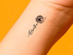 a small dandelion tattoo on the wrist that says,'happy birthday '