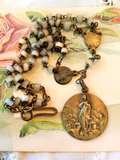 My inspiration was a very old and slightly worn bronze Mary and Jesus medal. I added another Tony rosary and hung it from antique glass rosary beads. very rustic and beautiful.  The necklace is  18" long and the medal is 7/8" Vintage Crucifix Necklace With Miraculous Medal, Mary And Jesus, Bib Necklaces, Rosary Beads, Antique Glass, Everyday Jewelry, Rosary, Assemblage, Wedding Shop