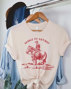 Saddle up Anyway Graphic Tee Western Tshirt Wild West - Etsy Western Designs For Shirts, Wild West Tshirt, Unisex Red Screen Print Tops, Red Shirt With Funny Print And Relaxed Fit, Red Shirt With Funny Print Relaxed Fit, Unisex Custom Print Graphic Tee, Red Relaxed Fit Shirt With Funny Print, Red Tops With Funny Print And Relaxed Fit, Graphic Tee With Custom Print And Relaxed Fit