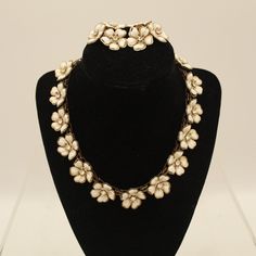 "V9624 This is a vintage white necklace with rhinestones, and a pair of earrings. The necklace features 13 flowers all around, and the earrings have 3 flowers. This jewelry set is very beautifully detailed and in excellent condition.  Size (necklace): 15.75\" x 1\" Earrings: 1.75\" x 1.5\" x .75\" If you are interested in purchasing more than one item from our shop and/or inquire about reduced shipping rates--send us your zip code. Also, please contact us for International shipping rates." Black Leaves, Skull Necklace, White Necklace, Wedding Jewellery Necklace, Short Necklace, Rhinestone Necklace, Clip Earrings, Zip Code, Wedding Necklace