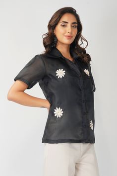 ▶ ABOUT THE TOP: This black organza shirt is a statement of style. Hand embroidered with sequin and beads in shape of daisy flowers. It comes with a satin lycra slip. Perfect for a day out at the office or a casual brunch with your friends. Made from organza fabric, the top has a loose fit and we offer it in plus sizes up to 5XL. ▶ ITEM DETAILS: * Top made with organza, comes with satin lycra slip * The model is 5'7 tall and wearing size M. * Handmade item, crafted to perfection. * The length of Fitted Embroidered Top With Collared Neckline, Fitted Floral Embroidery Top With Collared Neckline, Spring Embellished Fitted Shirt, Black Collared Shirt With Floral Embroidery, Black Embroidered Top With Collar, Fitted Embroidered Organza Blouse, Fitted Organza Blouse With Embroidery, Black Embellished Shirt For Party, Fitted Sequin Shirt For Spring