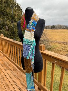 This scarf is handmade from of special yarns in multiple colors.   This scarf can be worn looped around your neck once or twice.  These scarves always make a statement!